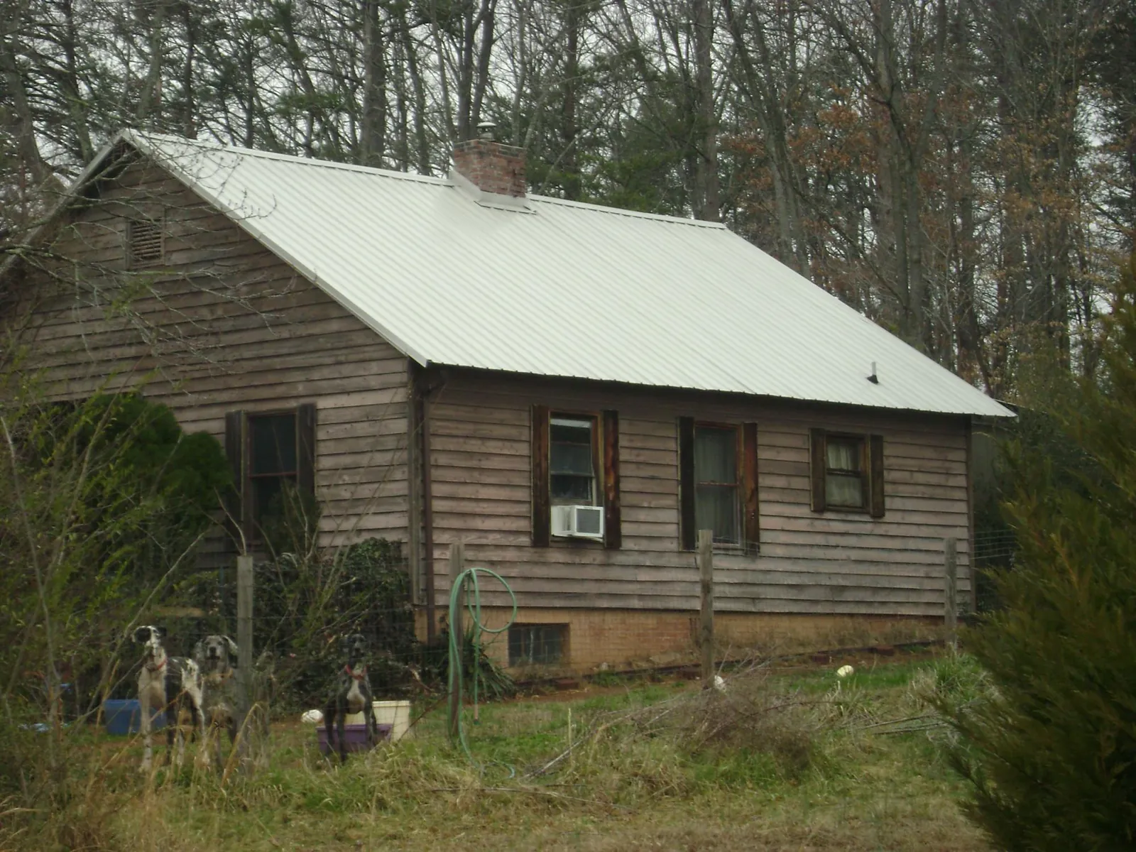 White metal roof on an old wood sided farmhouse, from a Metal Roof Installation job in South Kent